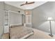 Bedroom featuring a Murphy bed, ceiling fan, neutral walls, and window at 18097 W Santa Alberta Ln, Goodyear, AZ 85338