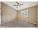 Empty bedroom with neutral carpeting and a window provides natural light and ventilation at 18097 W Santa Alberta Ln, Goodyear, AZ 85338