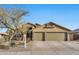 Charming front exterior showcasing a well-maintained lawn and a spacious three-car garage and neutral colored exterior at 18097 W Santa Alberta Ln, Goodyear, AZ 85338