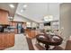 Eat-in kitchen showcasing a dining table with seating, stainless steel appliances, and a spacious countertop at 18097 W Santa Alberta Ln, Goodyear, AZ 85338