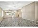 Spacious living room with wood floors, an open floor plan, ample natural light, and elegant light fixtures at 18097 W Santa Alberta Ln, Goodyear, AZ 85338