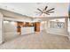 Open-concept living room with tile floors, a high ceiling, and seamless access to the kitchen area at 18097 W Santa Alberta Ln, Goodyear, AZ 85338