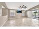 Bright living room with tile floors, neutral walls, and sliding door to outdoor space at 18097 W Santa Alberta Ln, Goodyear, AZ 85338