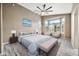 Stylish main bedroom with a bay window sitting area and a ceiling fan at 18097 W Santa Alberta Ln, Goodyear, AZ 85338