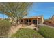 Aerial view of backyard featuring covered patio, outdoor seating, and lush landscaping at 18670 N Rincon Ct, Surprise, AZ 85387