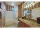 Well-lit bathroom featuring striped walls, granite counters, and a shower-tub combo at 18670 N Rincon Ct, Surprise, AZ 85387