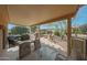 Relaxing covered patio featuring a dining area, lounge seating, and a fire pit at 18670 N Rincon Ct, Surprise, AZ 85387