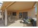 Inviting covered patio featuring comfortable seating and a tranquil outdoor space at 18670 N Rincon Ct, Surprise, AZ 85387