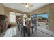 Elegant dining room featuring a large table, stylish chairs, and sliding glass doors to the patio at 18670 N Rincon Ct, Surprise, AZ 85387