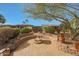 Outdoor fire pit with stone seating area, perfect for entertaining and enjoying the evening air at 18670 N Rincon Ct, Surprise, AZ 85387