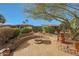 Beautiful backyard with custom-built brick fire pit and surrounding seating at 18670 N Rincon Ct, Surprise, AZ 85387