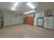 Spacious garage with epoxy floors, ample lighting, and built-in storage cabinets at 18670 N Rincon Ct, Surprise, AZ 85387