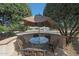 Charming outdoor patio featuring a table, chairs and a sun umbrella at 18670 N Rincon Ct, Surprise, AZ 85387