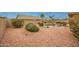 This backyard features a pool, patio furniture, a rock ground cover and mature landscaping at 18730 N 89Th Ave, Peoria, AZ 85382