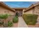 Landscaped walkway to the front door with stone accents, a tiled path and mature shrubbery at 18730 N 89Th Ave, Peoria, AZ 85382