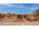 Welcoming single-story home with neat desert landscaping, a two-car garage, and a brick-paved driveway at 18730 N 89Th Ave, Peoria, AZ 85382