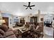 Bright living room with tile flooring, a ceiling fan, and abundant natural light at 18730 N 89Th Ave, Peoria, AZ 85382