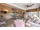 Relaxing sun room featuring tile flooring, ample seating, and a ceiling fan at 18730 N 89Th Ave, Peoria, AZ 85382