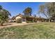 Spacious backyard with desert landscaping, mature plants, and a partially screened-in patio at 19503 N 142Nd Dr, Sun City West, AZ 85375