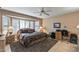 Bedroom featuring ceiling fan, natural light and tile flooring at 19503 N 142Nd Dr, Sun City West, AZ 85375