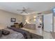 Cozy bedroom featuring a ceiling fan, desk, and dresser, offering a comfortable and functional living space at 19503 N 142Nd Dr, Sun City West, AZ 85375