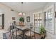 Cozy dining room with a chandelier, shuttered windows, and stylish decor at 19503 N 142Nd Dr, Sun City West, AZ 85375