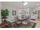 Inviting dining area features a skylight, shuttered windows, and a charming chandelier at 19503 N 142Nd Dr, Sun City West, AZ 85375