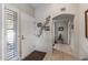 Welcoming entryway features tile flooring, shuttered sidelight, and decorative wall accents at 19503 N 142Nd Dr, Sun City West, AZ 85375