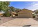 Well-maintained house boasts a large driveway, two-car garage, and low-maintenance desert landscaping at 19503 N 142Nd Dr, Sun City West, AZ 85375