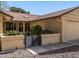 Close-up of a cozy home's entrance with desert landscape, shuttered windows, and a two-car garage at 19503 N 142Nd Dr, Sun City West, AZ 85375