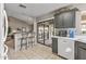 Kitchen showcasing a breakfast bar, seamlessly connecting to the living area, and providing outdoor access at 19503 N 142Nd Dr, Sun City West, AZ 85375