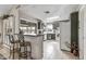 Well-lit kitchen with gray cabinetry, white appliances, breakfast bar, and convenient access to the outdoors at 19503 N 142Nd Dr, Sun City West, AZ 85375