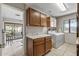 Well-equipped laundry room with cabinetry, counter, and modern appliances at 19503 N 142Nd Dr, Sun City West, AZ 85375