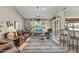 Bright living room featuring tile floors, a comfortable sofa, a ceiling fan, and a view of the outdoors at 19503 N 142Nd Dr, Sun City West, AZ 85375