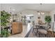 Open-concept living and dining areas featuring tile flooring, vaulted ceilings, and seamless flow to the kitchen at 19503 N 142Nd Dr, Sun City West, AZ 85375