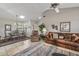 Cozy living area with tile floors, vaulted ceiling, seamlessly connected to a dining area with comfortable seating at 19503 N 142Nd Dr, Sun City West, AZ 85375