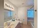 Bathroom featuring a vanity, toilet, and tub with tiled walls with natural light from a window at 19820 N 13Th Ave # 241, Phoenix, AZ 85027