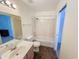 Well-lit bathroom with a shower-tub combo, single sink vanity, and brown tile flooring at 19820 N 13Th Ave # 241, Phoenix, AZ 85027