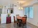 Cozy dining area with a chandelier, natural light, and adjacent kitchen view at 19820 N 13Th Ave # 241, Phoenix, AZ 85027