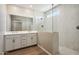 Bathroom featuring double sinks, vanity, glass enclosed shower with stylish tiling at 21052 N 58Th St, Phoenix, AZ 85054