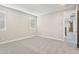 Neutral bedroom with plush carpet, ample natural light from two windows, and a view to the hallway at 21052 N 58Th St, Phoenix, AZ 85054