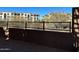 View of the community beyond a low block wall and wrought iron fence, showcasing the neighborhood's design at 21052 N 58Th St, Phoenix, AZ 85054