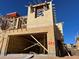 New home construction showcases the wood framing and design of a modern two-story house against a clear blue sky at 21052 N 58Th St, Phoenix, AZ 85054