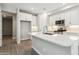 Open kitchen featuring white cabinets, quartz countertops, stainless steel appliances, and tile backsplash at 21052 N 58Th St, Phoenix, AZ 85054