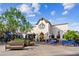 Inviting restaurant exterior with outdoor seating, blue benches, and lush landscaping at 21052 N 58Th St, Phoenix, AZ 85054