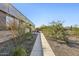 A view of the community path winding towards the pool area, framed by desert plants at 21052 N 58Th St, Phoenix, AZ 85054