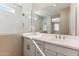 Bathroom showcasing a double sink vanity with modern faucets and a marble tiled glass shower at 21056 N 58Th St, Phoenix, AZ 85054