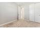 Bedroom boasts modern doors, neutral paint color, carpet floors, and plenty of closet space at 21056 N 58Th St, Phoenix, AZ 85054