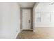 Bright entryway featuring a white front door, tile floors, and an open doorway to the next room at 21056 N 58Th St, Phoenix, AZ 85054