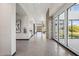 Bright hallway featuring modern design with stone accent wall, tiled floors, and large windows at 21056 N 58Th St, Phoenix, AZ 85054